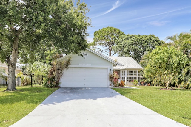2633 SE Export Ave, Port Saint Lucie, FL 34952 - view of front of home featuring concrete driveway and a garage