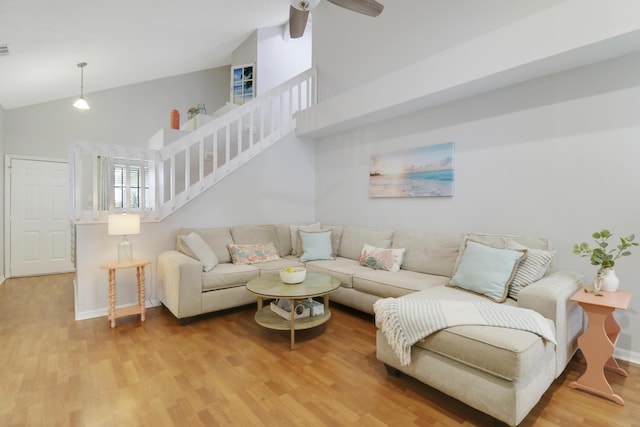 2633 SE Export Ave, Port Saint Lucie, FL 34952 - living area with high vaulted ceiling, light wood-style floors, ceiling fan, baseboards, and stairs