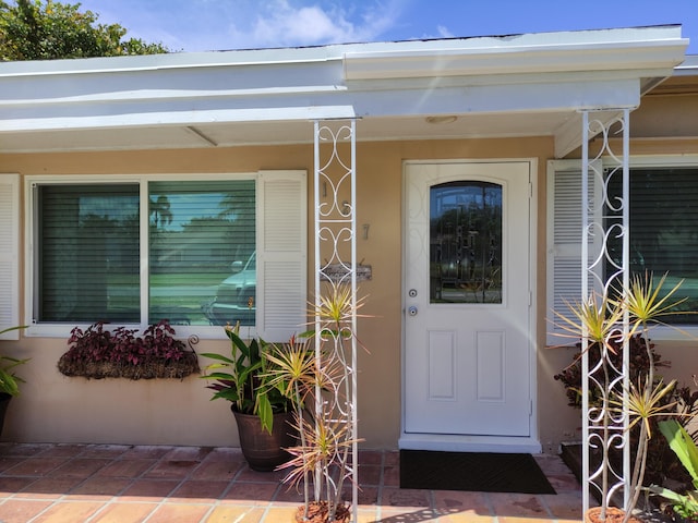 127 SW 12th Ave, Boynton Beach, FL 33435 - view of exterior entry with covered porch and stucco siding