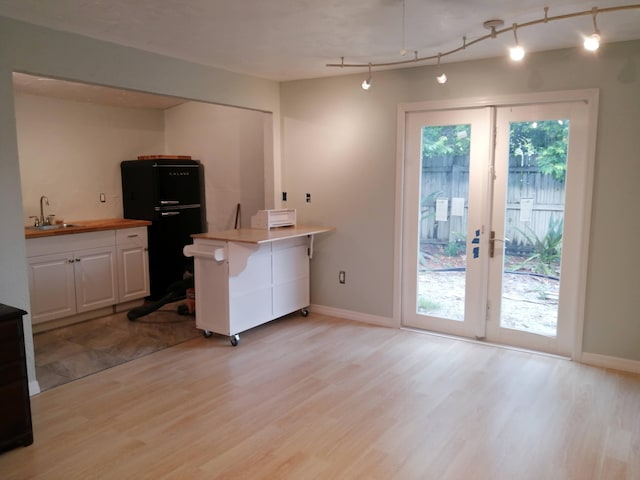 127 SW 12th Ave, Boynton Beach, FL 33435 - kitchen with white cabinetry, light wood-type flooring, plenty of natural light, and a sink
