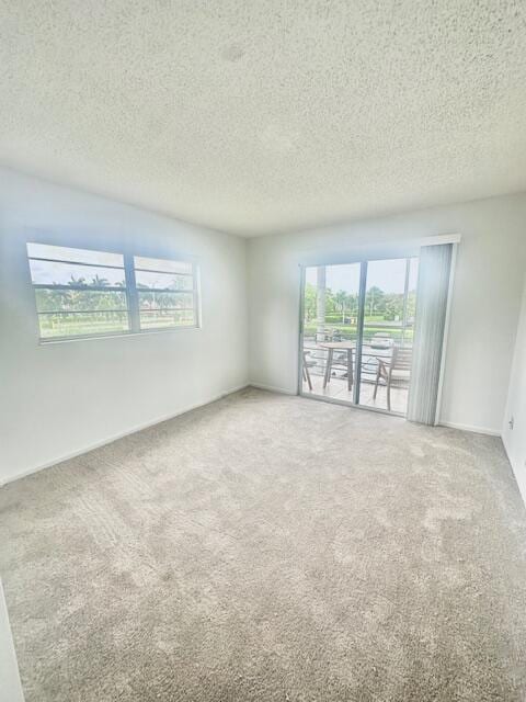 187 Preston E, Boca Raton, FL 33434 - carpeted empty room with a textured ceiling