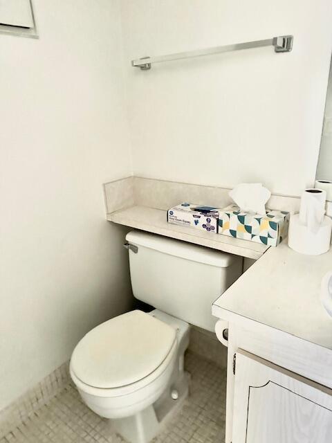 187 Preston E, Boca Raton, FL 33434 - half bathroom featuring vanity, tile patterned floors, and toilet