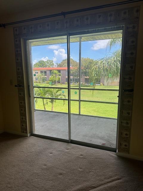 1947 SW Palm City Rd Unit G, Stuart, FL 34994 - doorway to outside with carpet floors