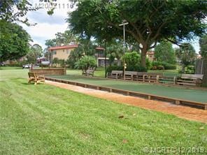 1947 SW Palm City Rd Unit G, Stuart, FL 34994 - view of community with a bocce ball area and a yard