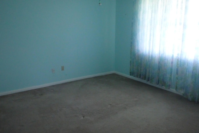 1947 SW Palm City Rd Unit G, Stuart, FL 34994 - carpeted empty room featuring baseboards