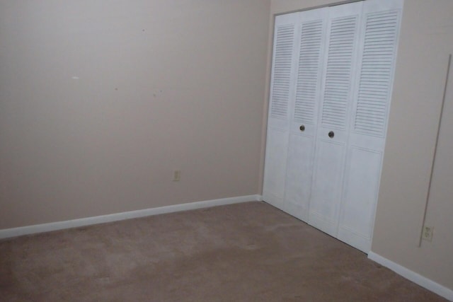 1947 SW Palm City Rd Unit G, Stuart, FL 34994 - unfurnished bedroom with light colored carpet, a closet, and baseboards
