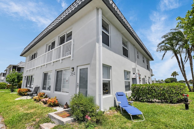 388 Tuscany G 388, Delray Beach, FL 33446 - rear view of house with stucco siding and a yard