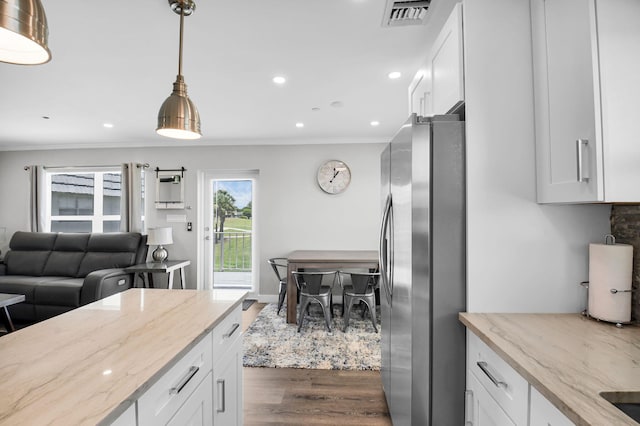 388 Tuscany G 388, Delray Beach, FL 33446 - kitchen featuring freestanding refrigerator, ornamental molding, dark wood-type flooring, white cabinets, and light stone counters