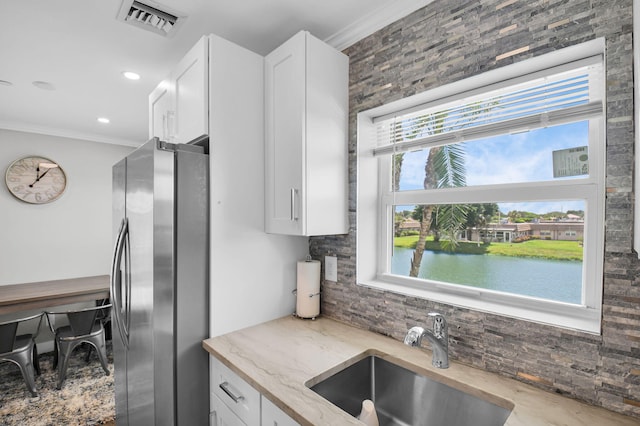 388 Tuscany G 388, Delray Beach, FL 33446 - kitchen featuring freestanding refrigerator, a sink, tasteful backsplash, crown molding, and light stone countertops