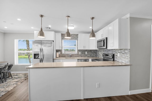 388 Tuscany G 388, Delray Beach, FL 33446 - kitchen with stainless steel appliances, a sink, tasteful backsplash, crown molding, and white cabinetry