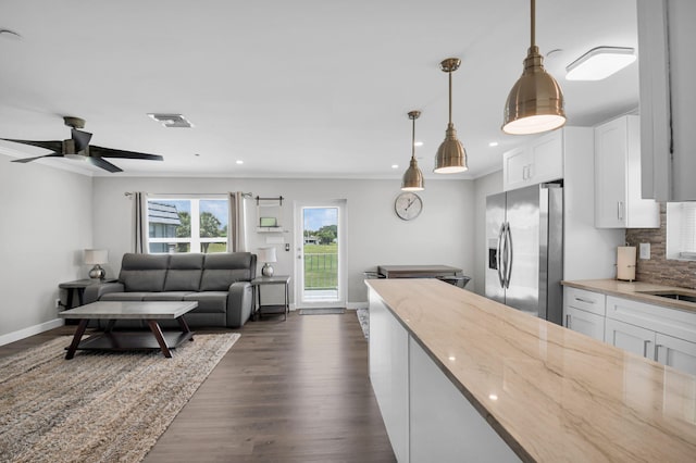 388 Tuscany G 388, Delray Beach, FL 33446 - kitchen featuring stainless steel fridge, backsplash, light stone counters, white cabinets, and recessed lighting