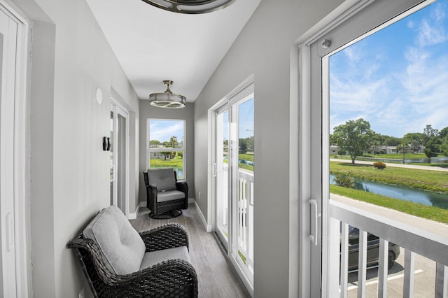 388 Tuscany G 388, Delray Beach, FL 33446 - sunroom / solarium featuring a water view, wood finished floors, and baseboards