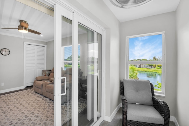 388 Tuscany G 388, Delray Beach, FL 33446 - living area with baseboards, a ceiling fan, crown molding, a water view, and wood finished floors