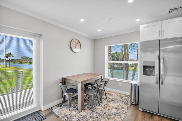 388 Tuscany G 388, Delray Beach, FL 33446 - dining room with baseboards, ornamental molding, wood finished floors, recessed lighting, and a water view