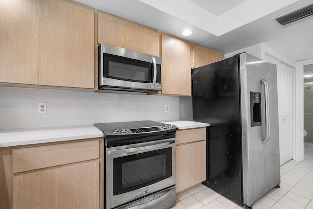 8111 Northboro Ct Unit 11B, Lake Clarke Shores, FL 33406 - kitchen with stainless steel appliances, light brown cabinets, light tile patterned flooring, and light countertops