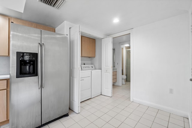 8111 Northboro Ct Unit 11B, Lake Clarke Shores, FL 33406 - kitchen with stainless steel fridge with ice dispenser, washing machine and dryer, light countertops, baseboards, and light tile patterned flooring
