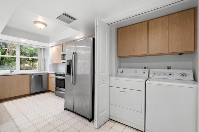 8111 Northboro Ct Unit 11B, Lake Clarke Shores, FL 33406 - laundry room featuring washing machine and dryer, cabinet space, and light tile patterned flooring