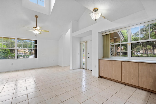 8111 Northboro Ct Unit 11B, Lake Clarke Shores, FL 33406 - unfurnished room with ceiling fan, light tile patterned floors, high vaulted ceiling, baseboards, and a skylight