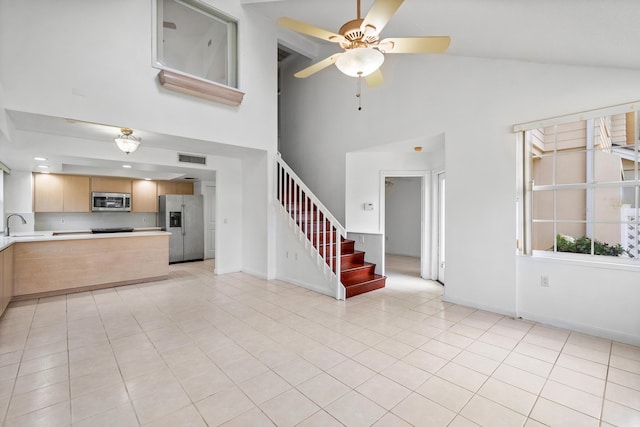 8111 Northboro Ct Unit 11B, Lake Clarke Shores, FL 33406 - unfurnished living room featuring stairway, high vaulted ceiling, ceiling fan, light tile patterned flooring, and baseboards