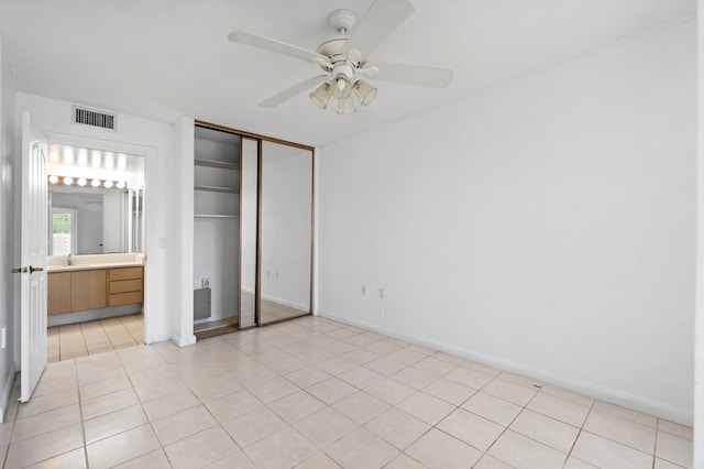 8111 Northboro Ct Unit 11B, Lake Clarke Shores, FL 33406 - unfurnished bedroom with light tile patterned flooring, a closet, baseboards, a sink, and a ceiling fan