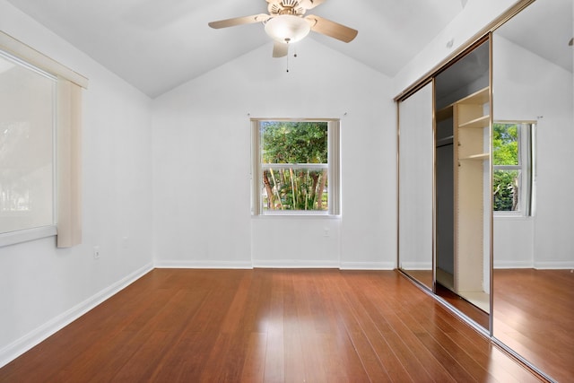 8111 Northboro Ct Unit 11B, Lake Clarke Shores, FL 33406 - unfurnished bedroom with wood finished floors, multiple windows, vaulted ceiling, a closet, and ceiling fan