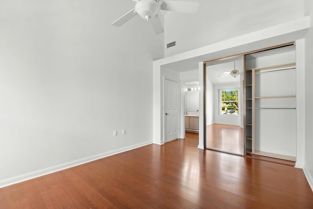 8111 Northboro Ct Unit 11B, Lake Clarke Shores, FL 33406 - unfurnished bedroom featuring wood finished floors, baseboards, a towering ceiling, ceiling fan, and a closet