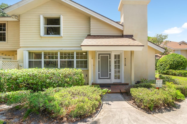 8111 Northboro Ct Unit 11B, Lake Clarke Shores, FL 33406 - view of front of property with a chimney, a shingled roof, and stucco siding