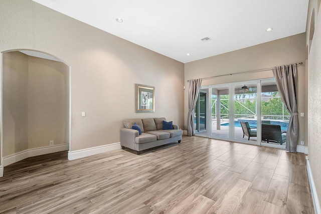 21480 Halstead Dr, Boca Raton, FL 33428 - living room with light wood-style flooring, arched walkways, and recessed lighting