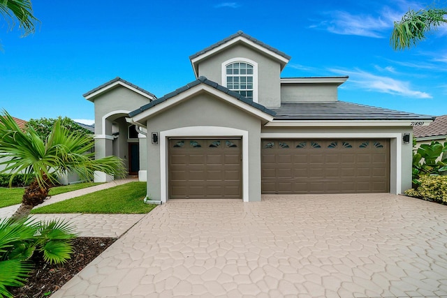 21480 Halstead Dr, Boca Raton, FL 33428 - view of front of house featuring stucco siding, decorative driveway, a tile roof, and an attached garage