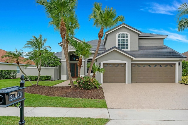 21480 Halstead Dr, Boca Raton, FL 33428 - view of front of house featuring driveway, stucco siding, a garage, and a tile roof