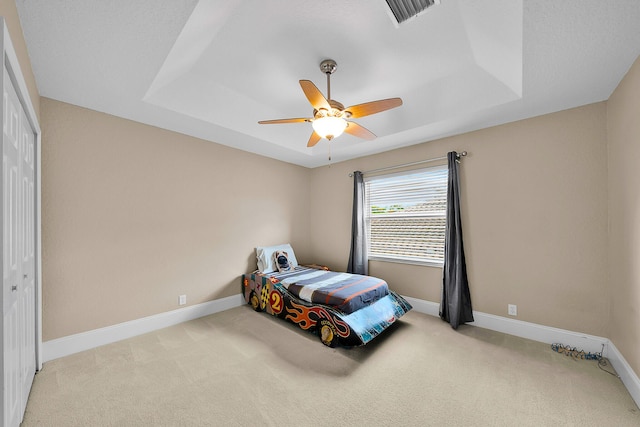 21480 Halstead Dr, Boca Raton, FL 33428 - carpeted bedroom featuring a tray ceiling, ceiling fan, and a closet
