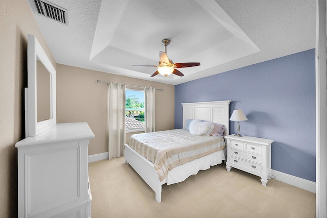 21480 Halstead Dr, Boca Raton, FL 33428 - bedroom with a tray ceiling, light carpet, a textured ceiling, and ceiling fan