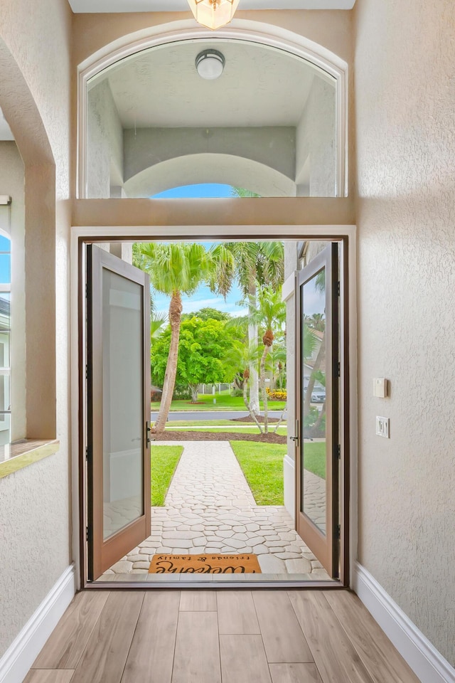 21480 Halstead Dr, Boca Raton, FL 33428 - doorway to outside with wood finished floors and a textured wall