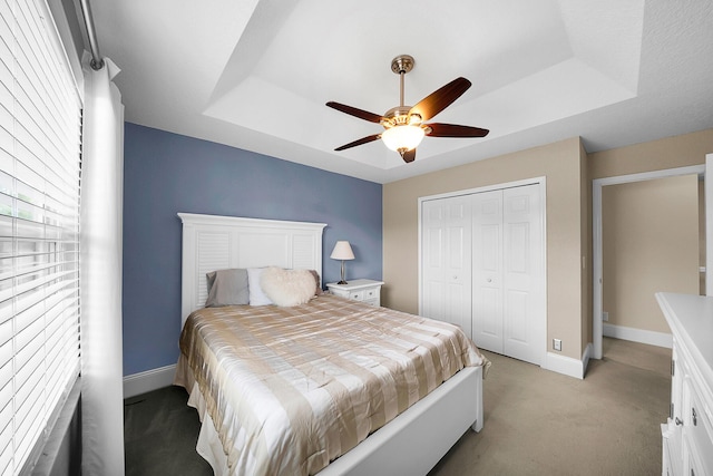 21480 Halstead Dr, Boca Raton, FL 33428 - bedroom featuring a tray ceiling, light carpet, a closet, and a ceiling fan