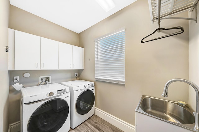 21480 Halstead Dr, Boca Raton, FL 33428 - washroom featuring cabinet space, washer and dryer, and light wood-type flooring