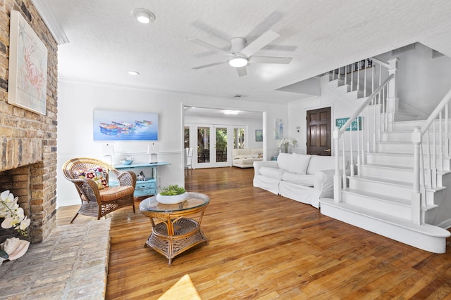 2070 Spring Pl, Vero Beach, FL 32963 - living room with a ceiling fan, stairway, wood finished floors, a fireplace, and a textured ceiling