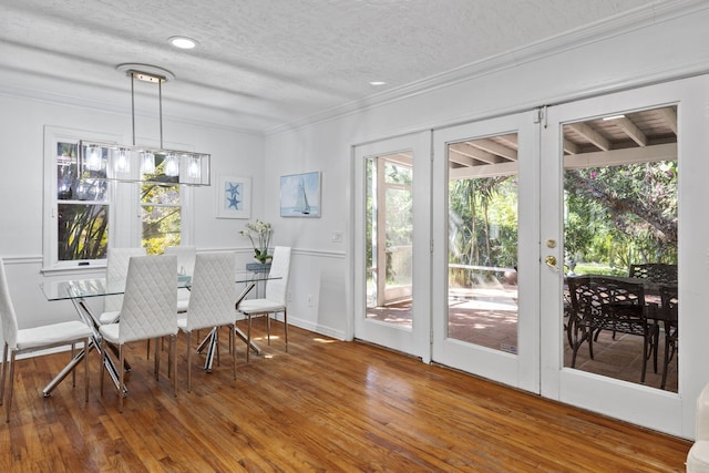 2070 Spring Pl, Vero Beach, FL 32963 - dining space with plenty of natural light, crown molding, wood finished floors, a textured ceiling, and baseboards
