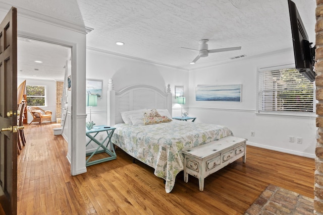 2070 Spring Pl, Vero Beach, FL 32963 - bedroom featuring light wood finished floors, ornamental molding, a textured ceiling, baseboards, and recessed lighting
