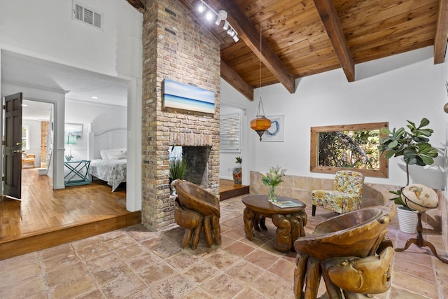 2070 Spring Pl, Vero Beach, FL 32963 - living area with wood ceiling with exposed beams, a fireplace, high vaulted ceiling, and healthy amount of natural light