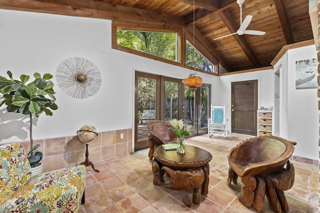 2070 Spring Pl, Vero Beach, FL 32963 - sitting room with wooden ceiling with exposed beams, ceiling fan, stone tile floors, high vaulted ceiling, and french doors