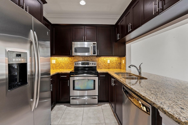 1579 Bow Line Rd, Fort Pierce, FL 34949 - kitchen featuring stainless steel appliances, light stone counters, light tile patterned floors, crown molding, and backsplash