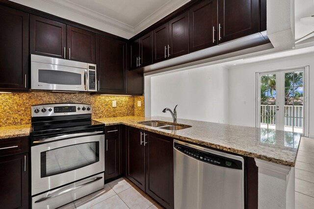 1579 Bow Line Rd, Fort Pierce, FL 34949 - kitchen featuring appliances with stainless steel finishes, crown molding, light stone counters, decorative backsplash, and light tile patterned floors