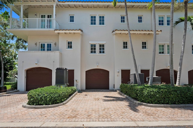 1579 Bow Line Rd, Fort Pierce, FL 34949 - view of front of house with a garage, stucco siding, driveway, and a balcony