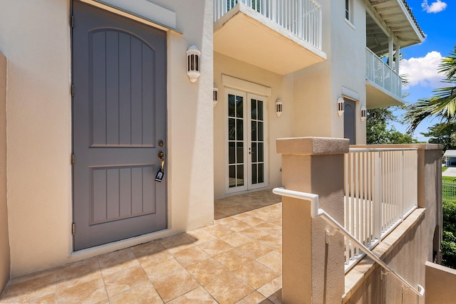 1579 Bow Line Rd, Fort Pierce, FL 34949 - entrance to property with french doors, a balcony, and stucco siding