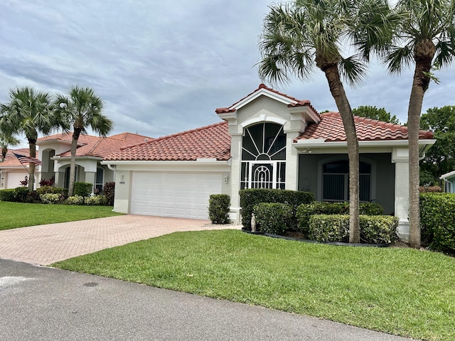 644 NW San Candido Way, Port Saint Lucie, FL 34986 - mediterranean / spanish home with decorative driveway, stucco siding, an attached garage, and a front yard