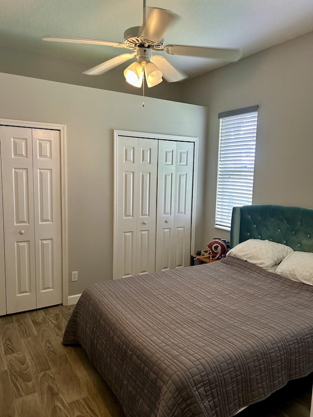644 NW San Candido Way, Port Saint Lucie, FL 34986 - bedroom with multiple closets, wood finished floors, and a ceiling fan
