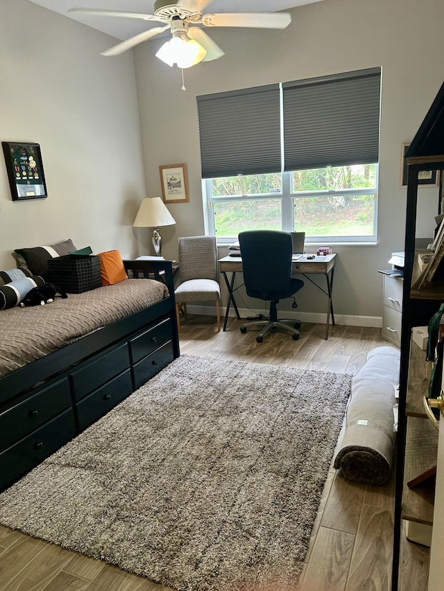644 NW San Candido Way, Port Saint Lucie, FL 34986 - bedroom featuring wood finished floors, a desk, baseboards, and a ceiling fan