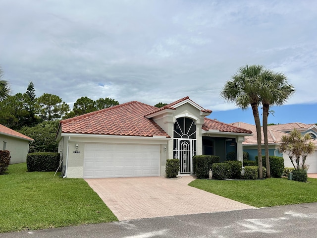 644 NW San Candido Way, Port Saint Lucie, FL 34986 - mediterranean / spanish house with a garage, decorative driveway, a front lawn, stucco siding, and a tiled roof