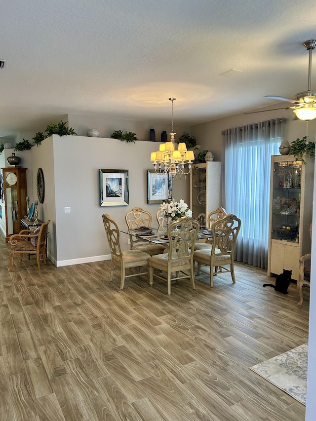 644 NW San Candido Way, Port Saint Lucie, FL 34986 - dining space featuring light wood finished floors, a chandelier, a ceiling fan, and baseboards