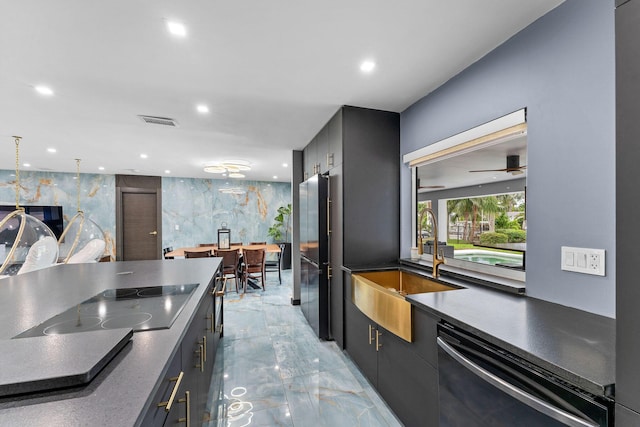 1772 SW Commodore Pl, Palm City, FL 34990 - kitchen with stainless steel dishwasher, black electric cooktop, freestanding refrigerator, a sink, and light marble finish floors